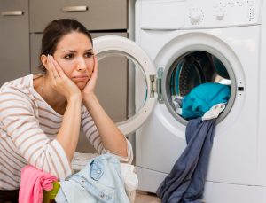 Stressed Woman Doing Laundry Medium Shot